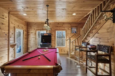 Peace of Mind cabin game room with pool table and arcade machine