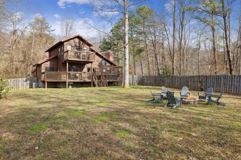 The Aerie fenced in yard with fire pit